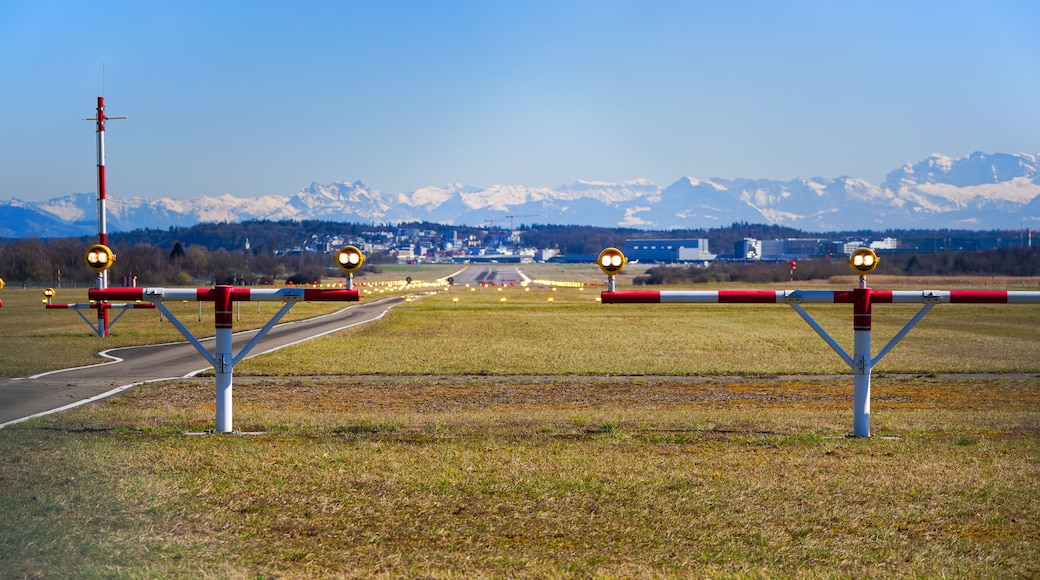 Scenic view of runway number 14 of Swiss Airport Zürich Kloten with beacons and snow covered Swiss Alps in the background on a sunny day. Photo taken March 19th, 2025, Zurich Kloten, Switzerland.