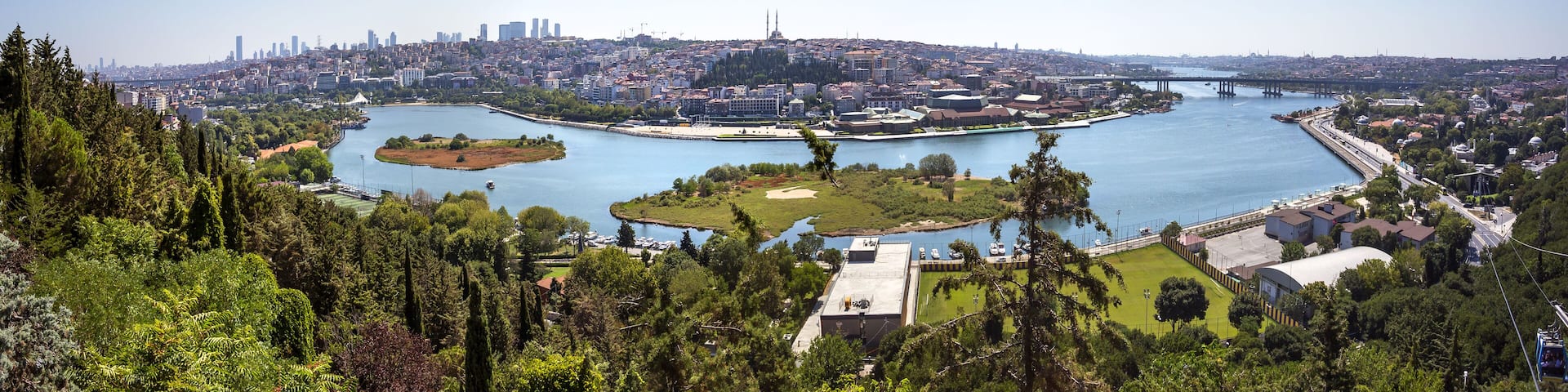 A cityscape with a river, bridges, and a prominent tower.