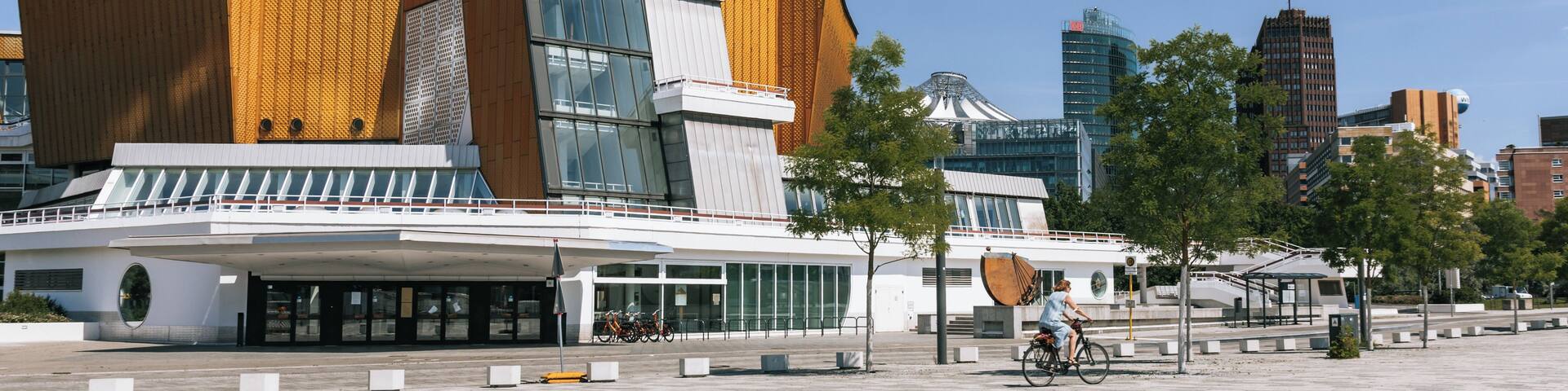 A modern building with a unique architectural design, featuring a mix of wooden and glass elements.