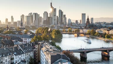 A cityscape with a river, a bridge, and a tall building.