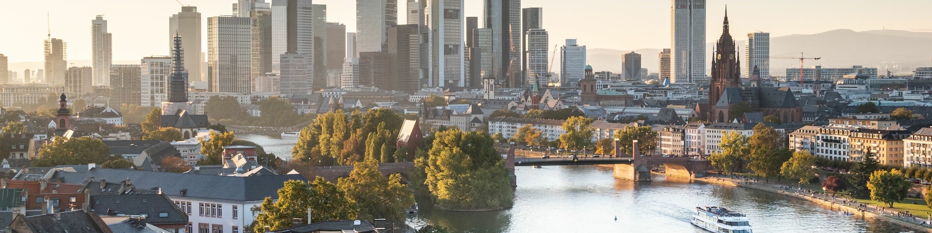 A cityscape with a river, a bridge, and a tall building.