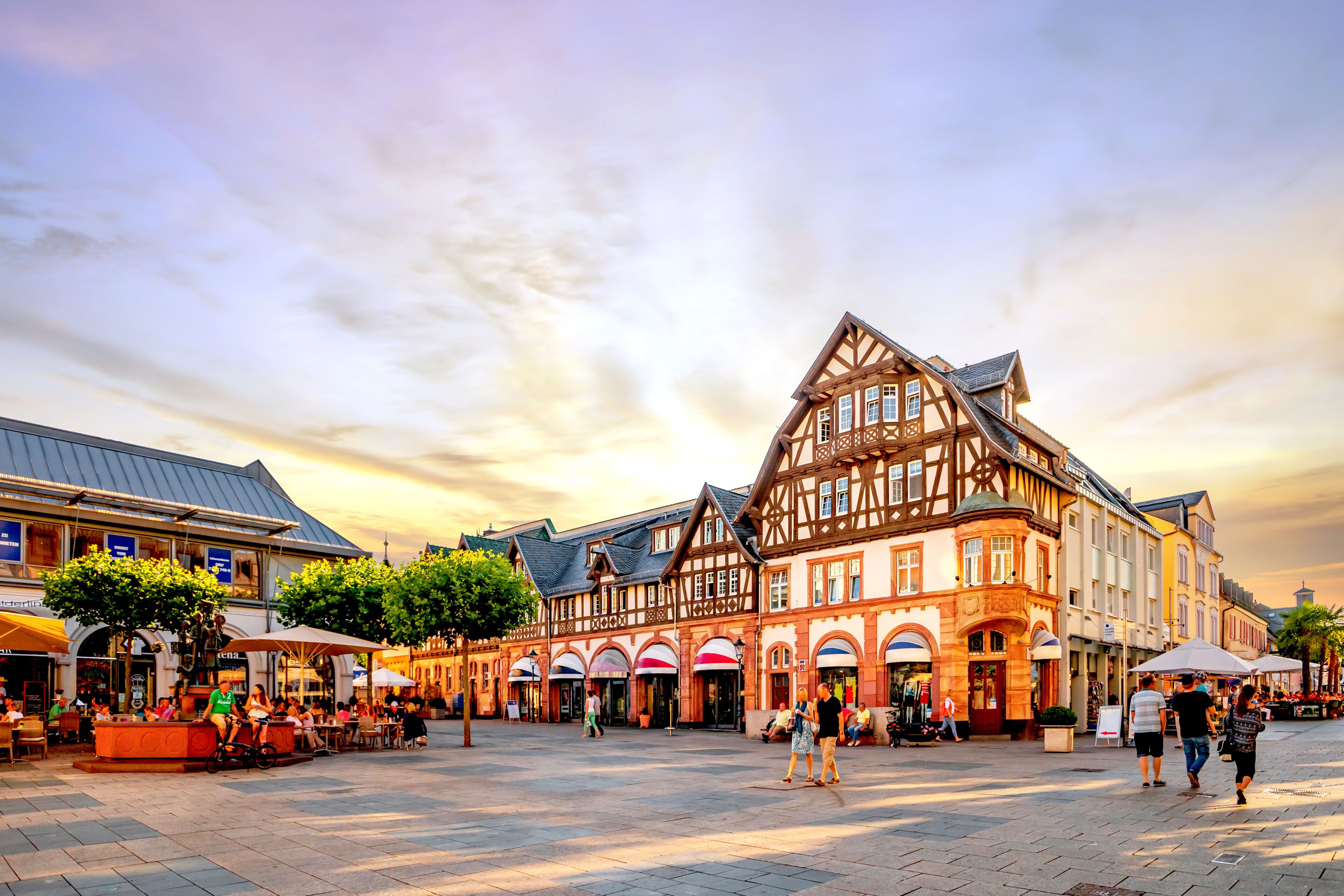 A historic half-timbered building with a courtyard and outdoor seating.