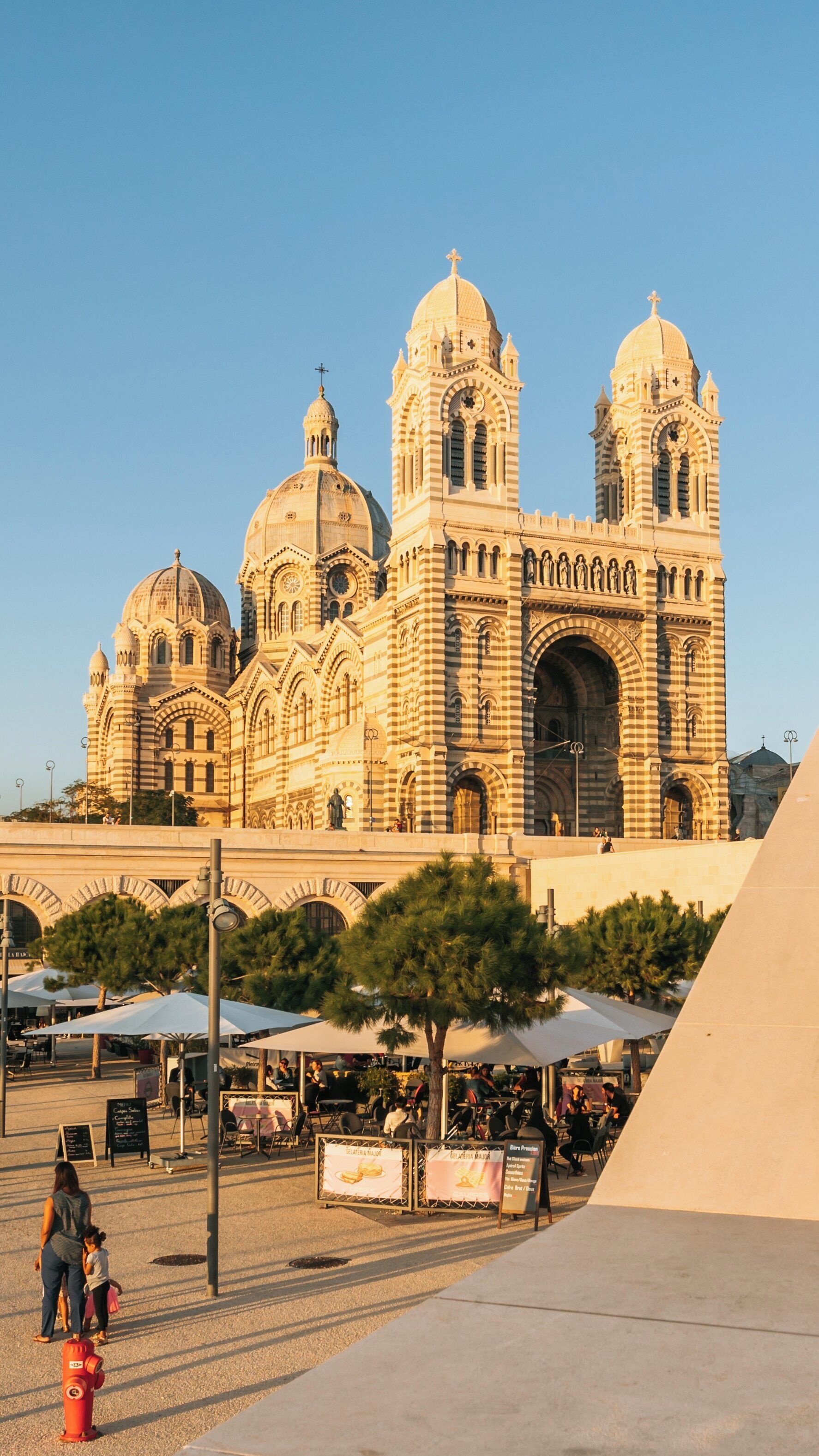 Cathedral la Major stands majestically in Marseille, Provence-Alpes-Côte d'Azur bathed in golden sunlight, showcasing its stunning architectural details during a clear day