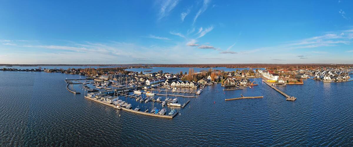 A harbor with boats, docks, and buildings along the water.