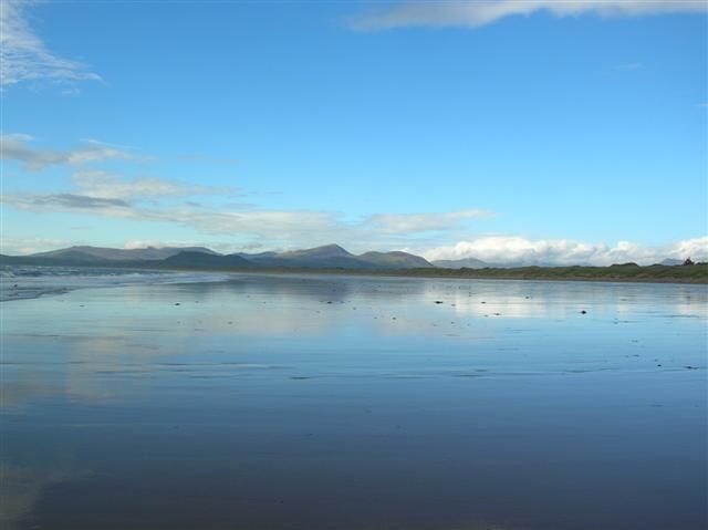 Wet beach at Harlech. With the beach reflecting just minutes after a huge thunderstorm. Looking north across to Porthmadog.
