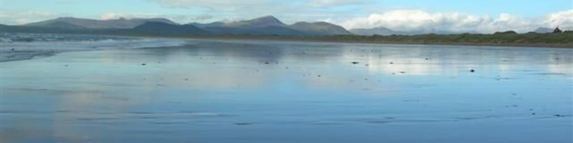 Wet beach at Harlech. With the beach reflecting just minutes after a huge thunderstorm. Looking north across to Porthmadog.