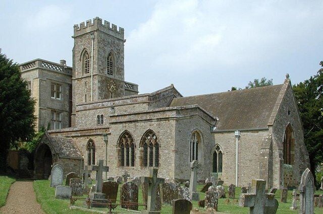A historic church with a tower and arched windows.