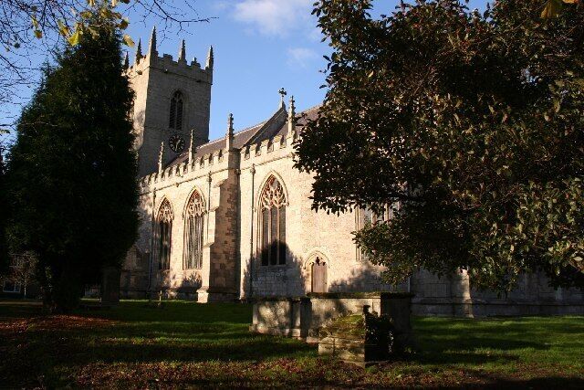 A historic church with a tall tower and arched windows.
