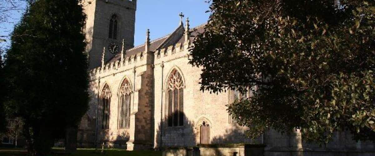 A historic church with a tall tower and arched windows.