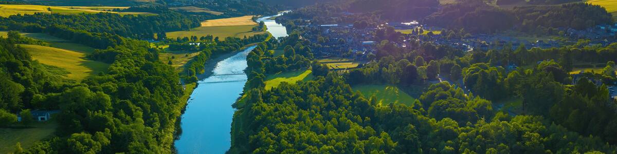 Aerial view of lush forest and meandering River Spey, Moray, Scotland.