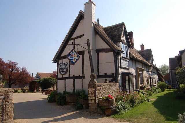 A traditional half-timbered building with a signboard.