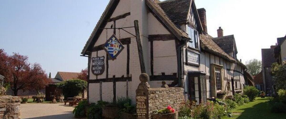 A traditional half-timbered building with a signboard.