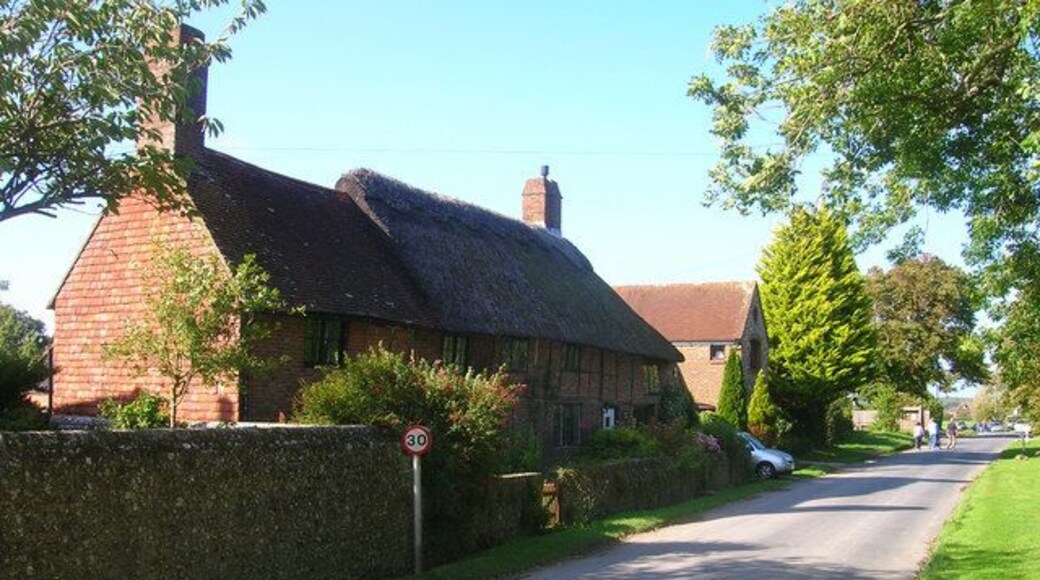 Pond Cottage, The Street The thatched part of the cottage seems to suggest a building from the 16th century. On the main village street as it heads towards the A27.