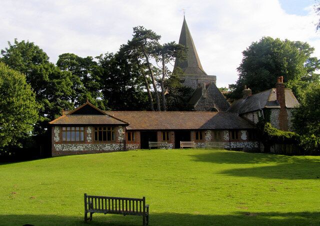 A large building with a prominent tower, surrounded by a well-maintained lawn and trees.