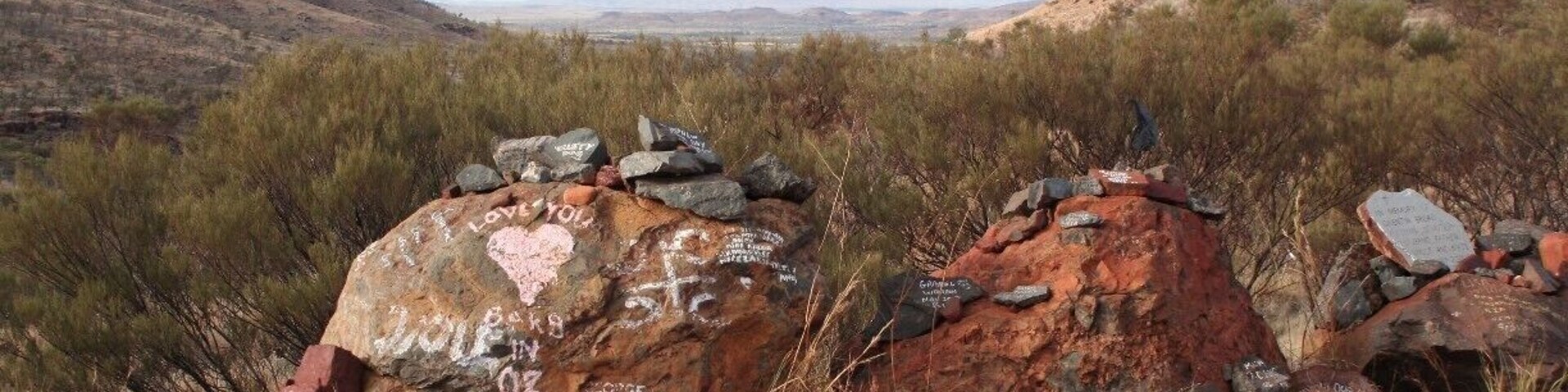 Driving from Karijini NP to Tom Price you'll pass the rest in peace lookout. Scattered over the parking are stones to remember people. The place also has a great view