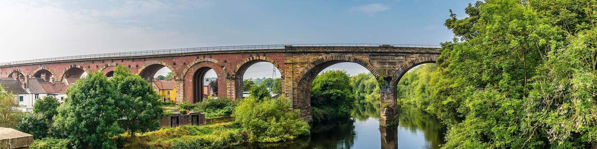 A panorama view from the road bridge towards the railway viaduct at Yarm, Yorkshire, UK in summertime