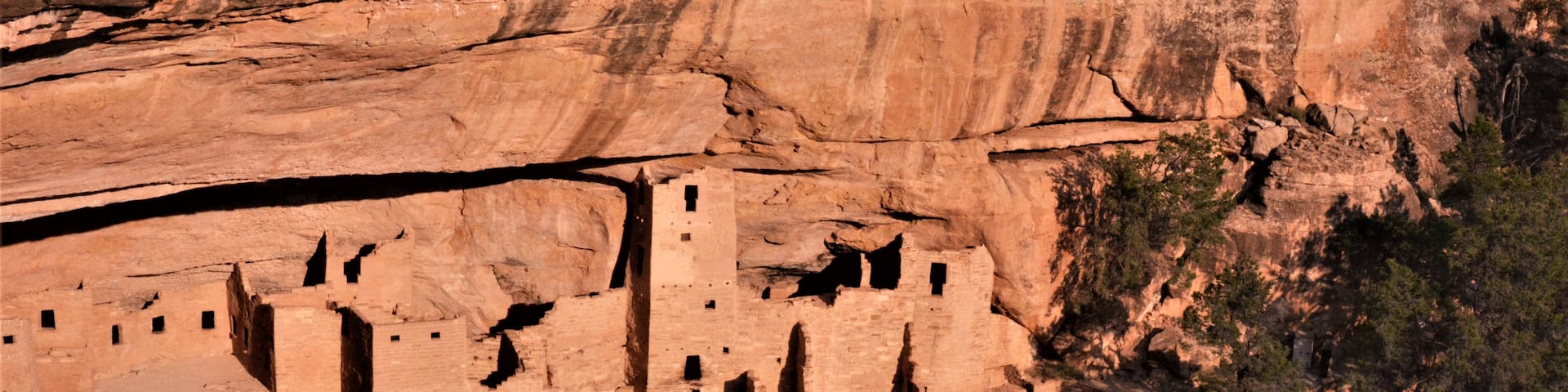 Ancient cliff dwellings carved into a canyon wall.