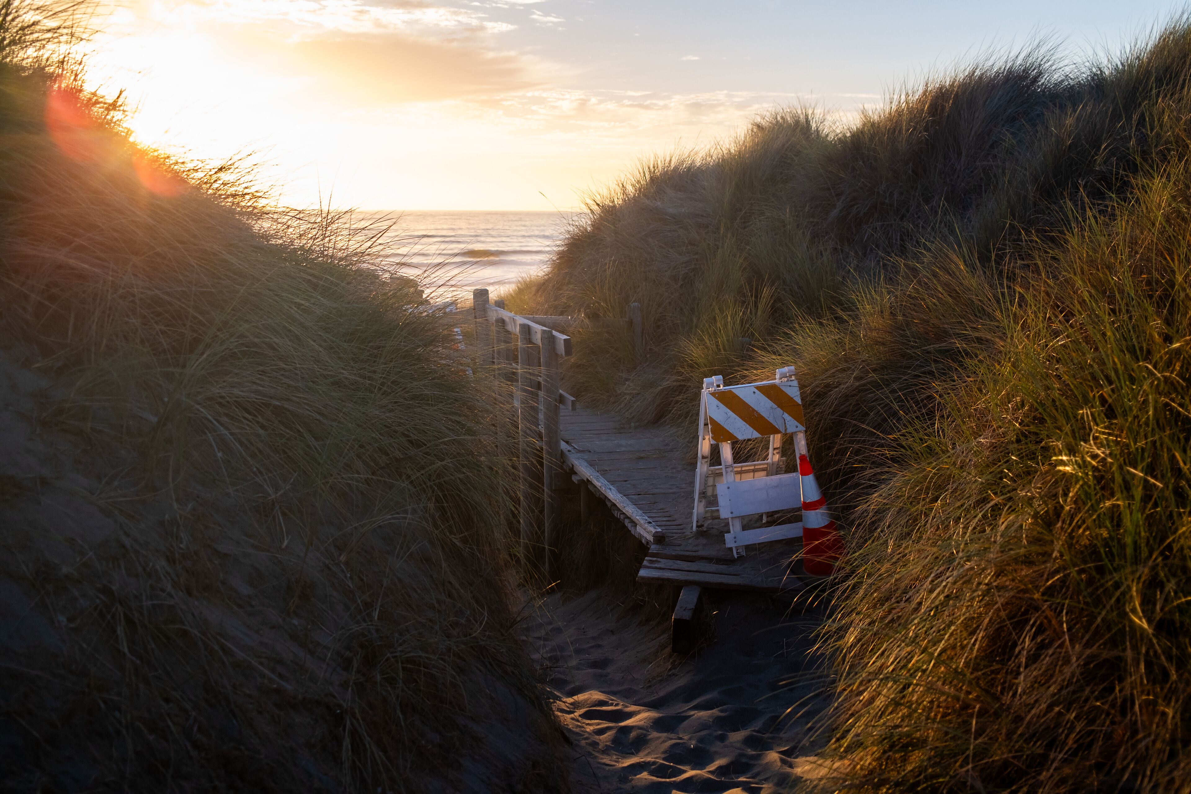 A beach path with a wooden boardwalk and a dune buggy.