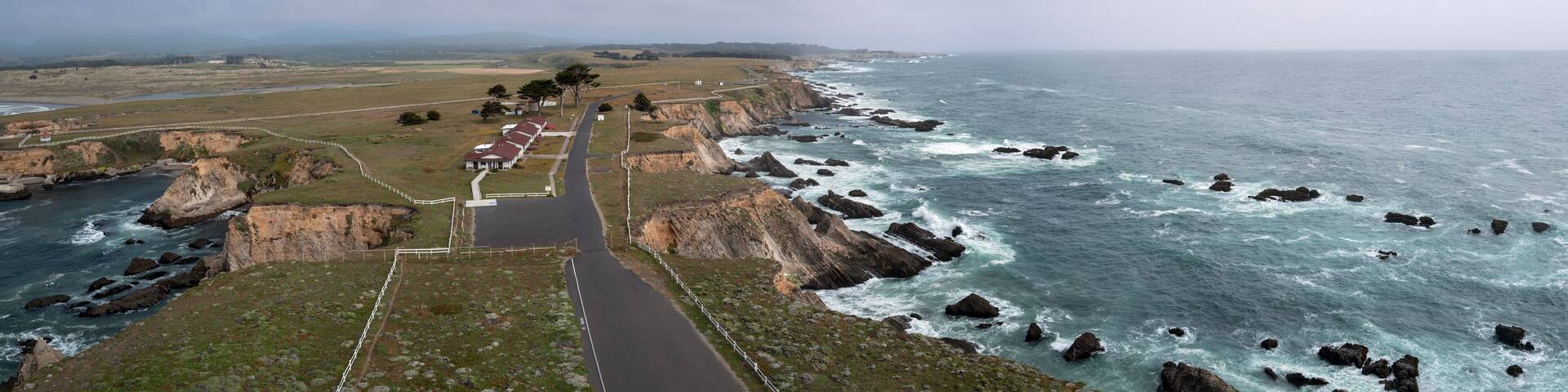 Aerial panorama of the grounds and Pacific Ocean coastline viewed from the tower at the Point Arena Lighthouse, California, USA