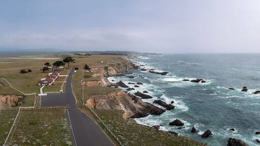 Aerial panorama of the grounds and Pacific Ocean coastline viewed from the tower at the Point Arena Lighthouse, California, USA