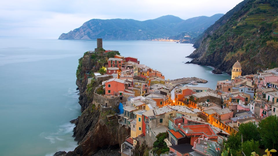 A coastal village with colorful buildings perched on a cliff overlooking the sea.