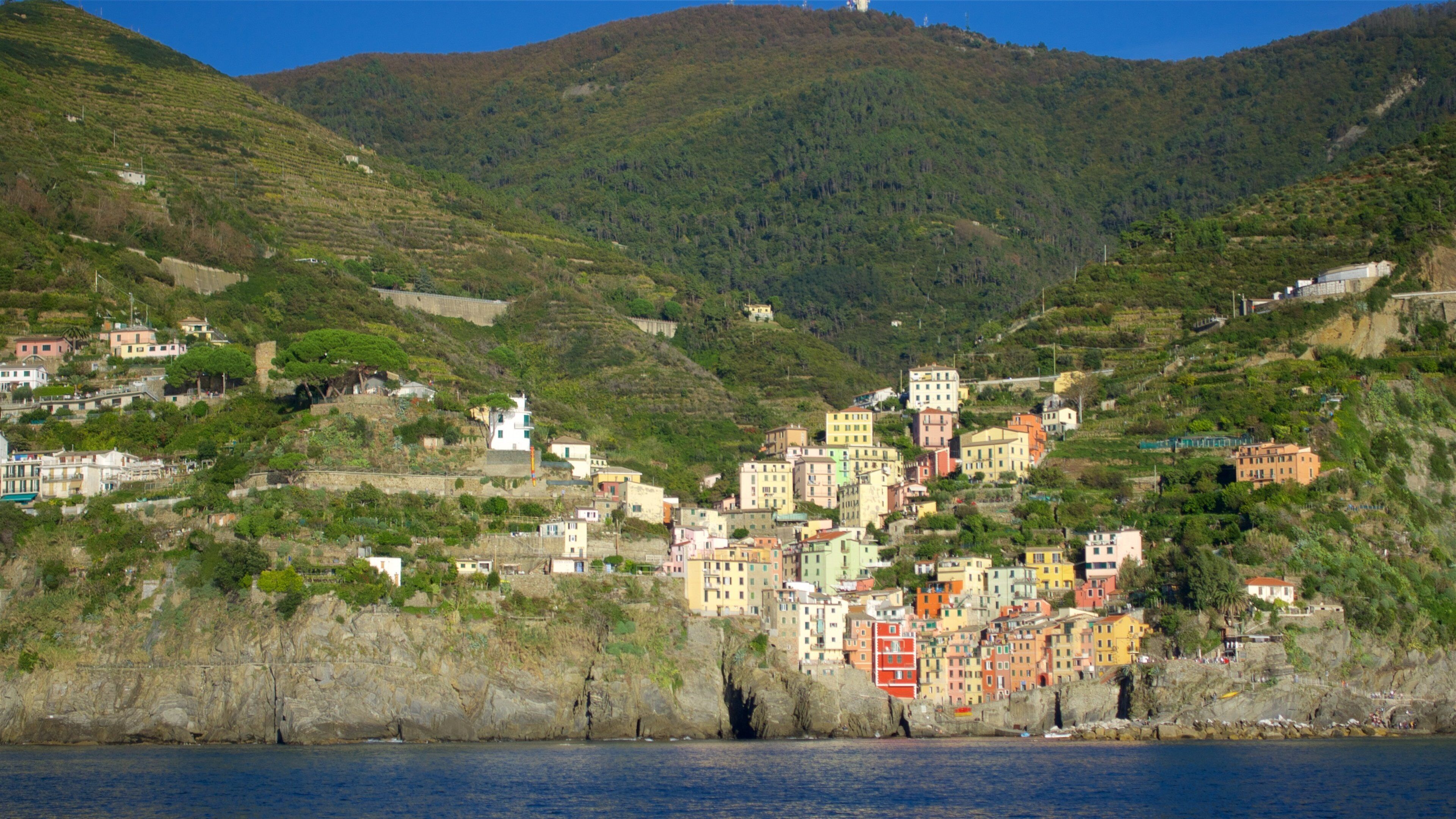 Riomaggiore featuring mountains, rugged coastline and a coastal town