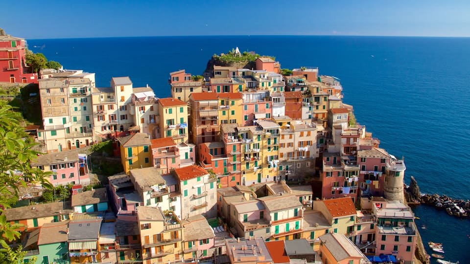 A coastal village with colorful buildings and a clear blue sea.