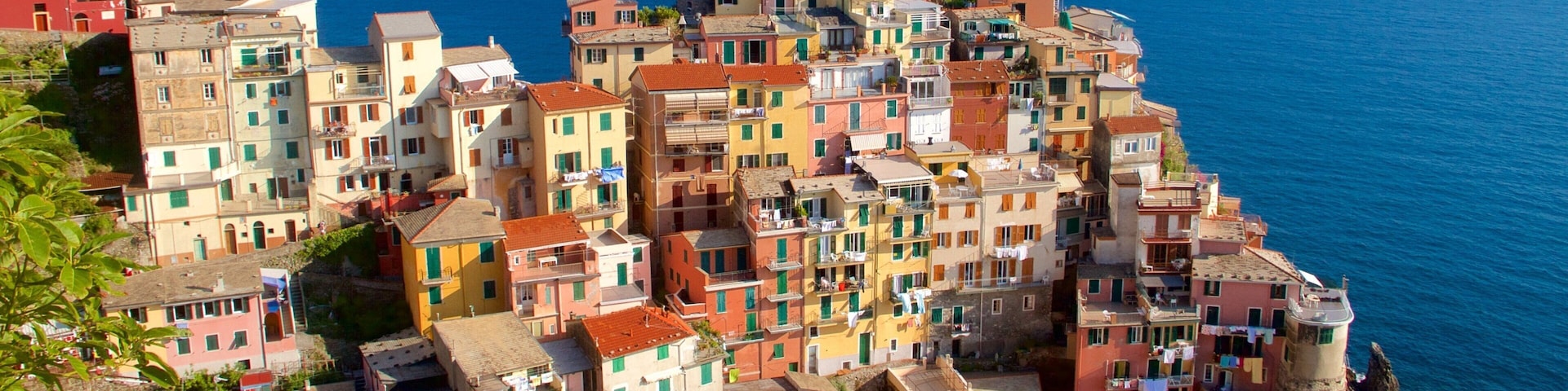 A coastal village with colorful buildings and a clear blue sea.