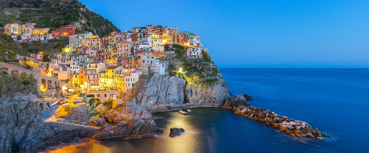 A coastal town with colorful buildings perched on a cliff overlooking the sea.