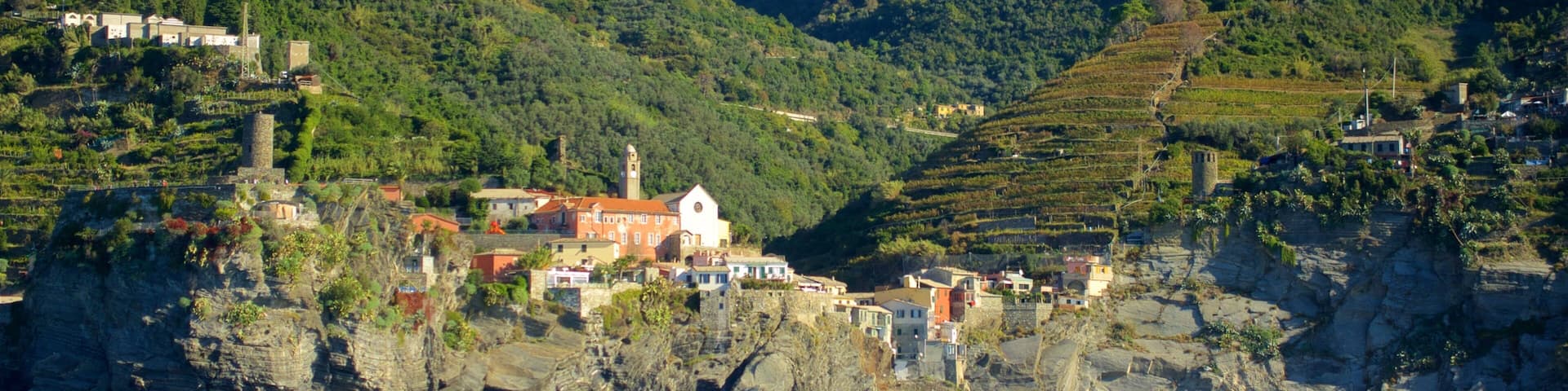 Corniglia which includes a coastal town, mountains and rocky coastline