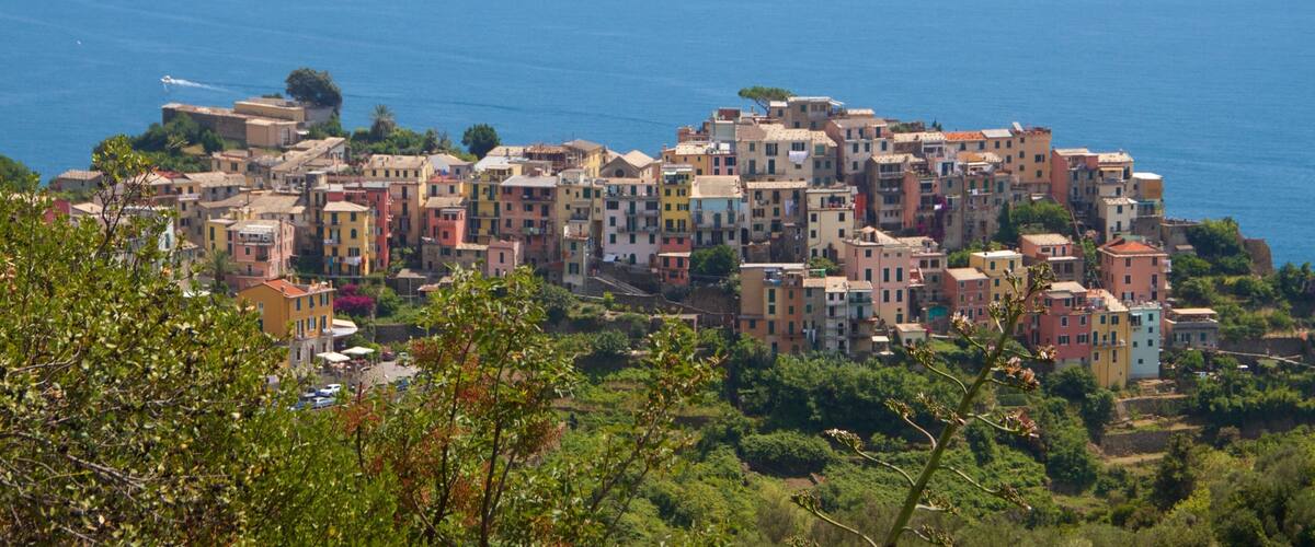 A coastal village with colorful buildings and a view of the sea.