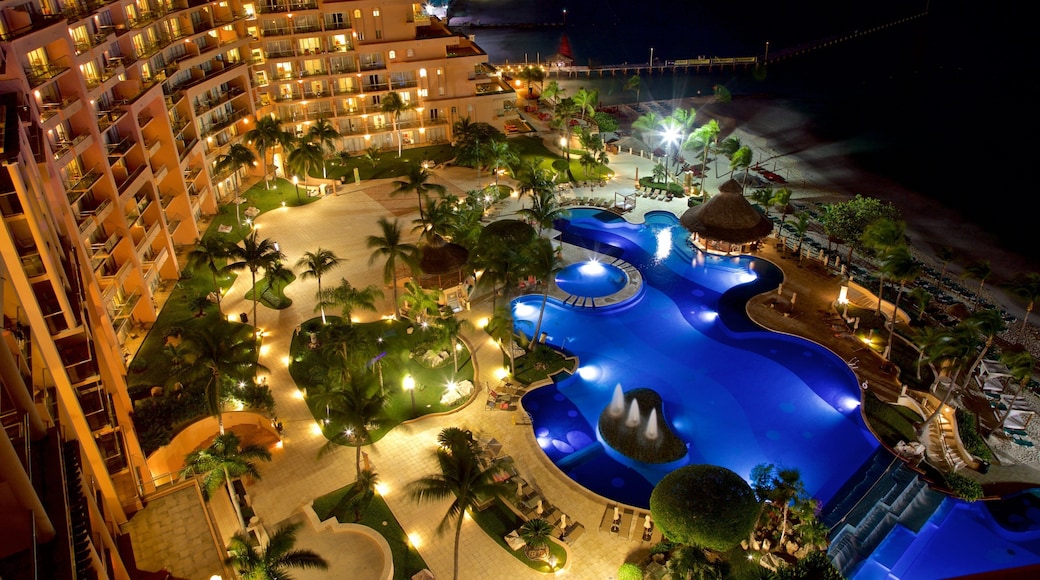 Cancun which includes a luxury hotel or resort, a pool and night scenes