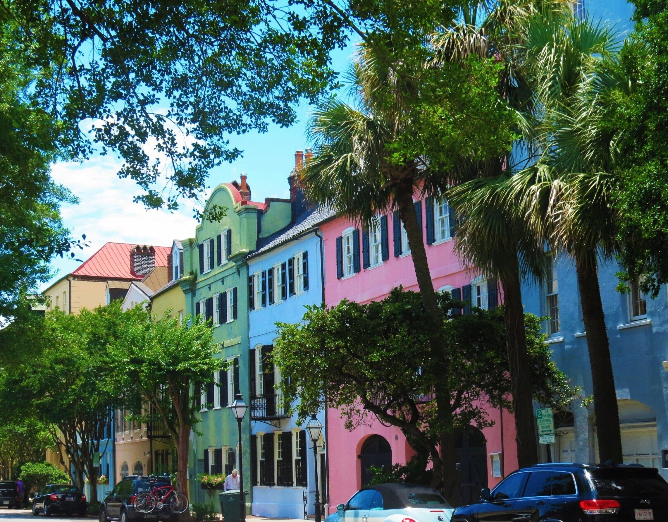 A row of colorful buildings with a street in front.