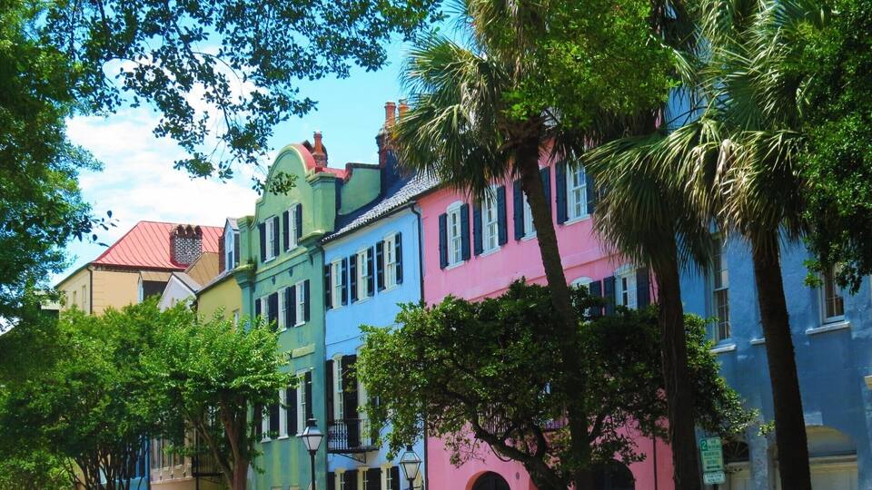 A row of colorful buildings with a street in front.