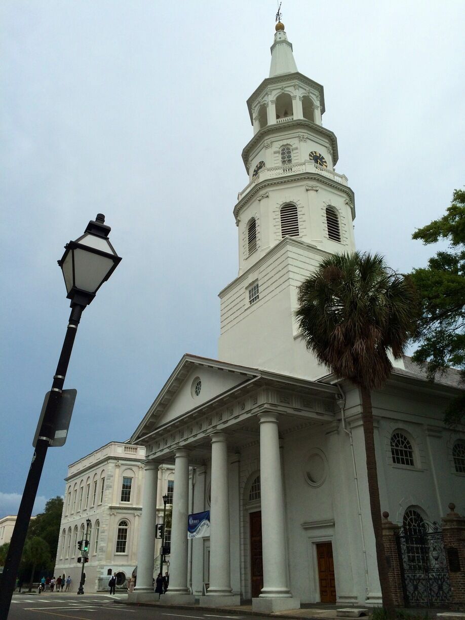 A white church with a clock tower and columns.
