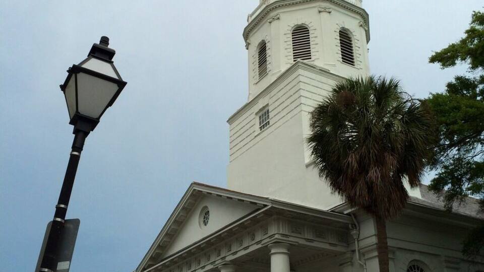 A white church with a clock tower and columns.