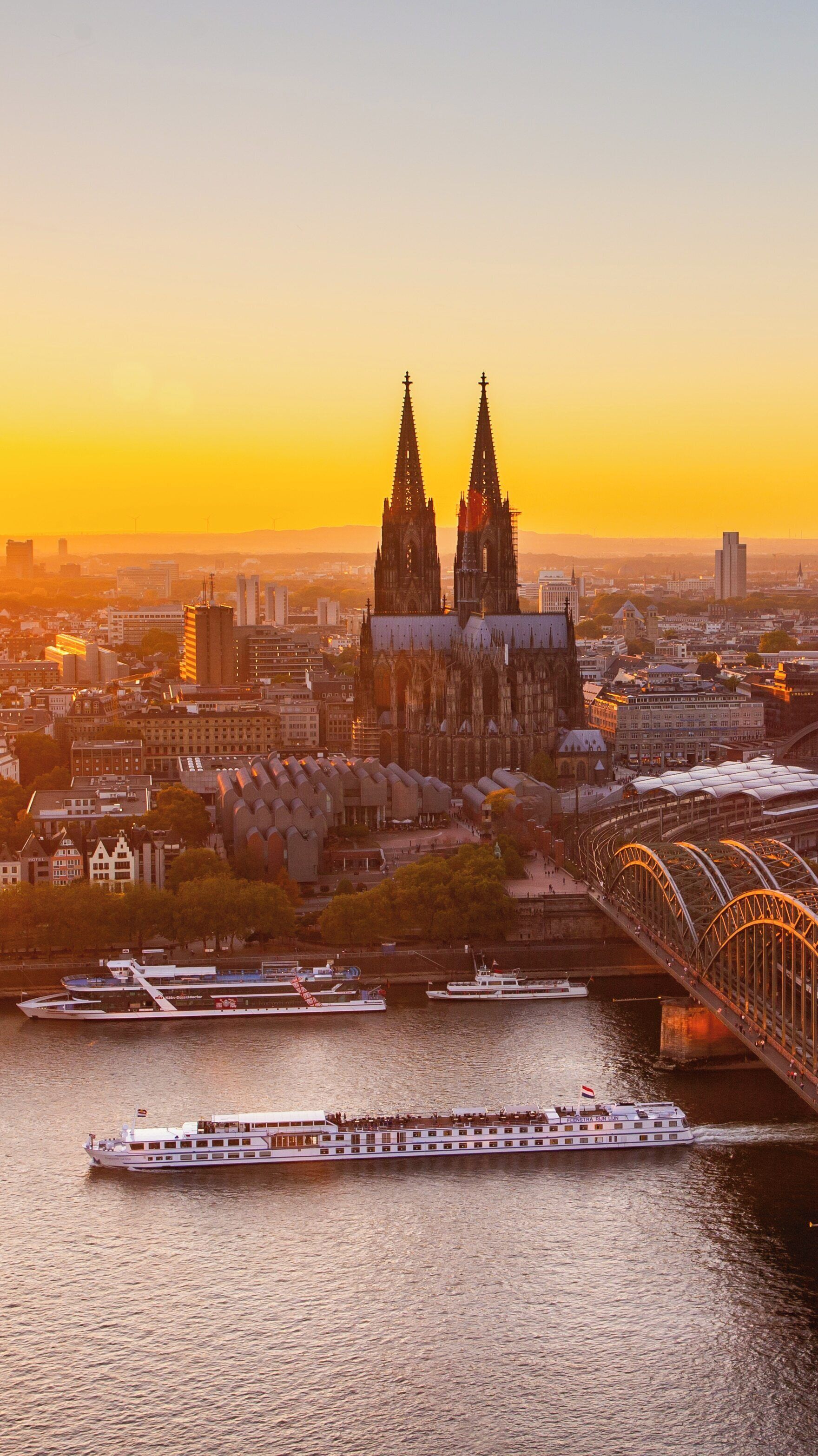 Sunset view of Cologne Triangle and Cologne Cathedral along the Rhine River in North Rhine-Westphalia, Germany