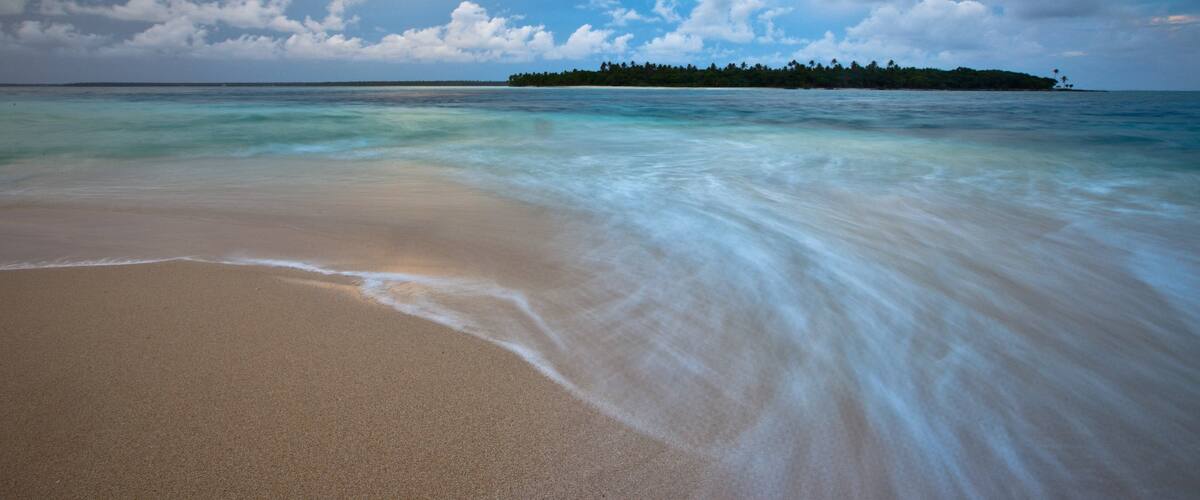 Tonga which includes general coastal views and a sandy beach
