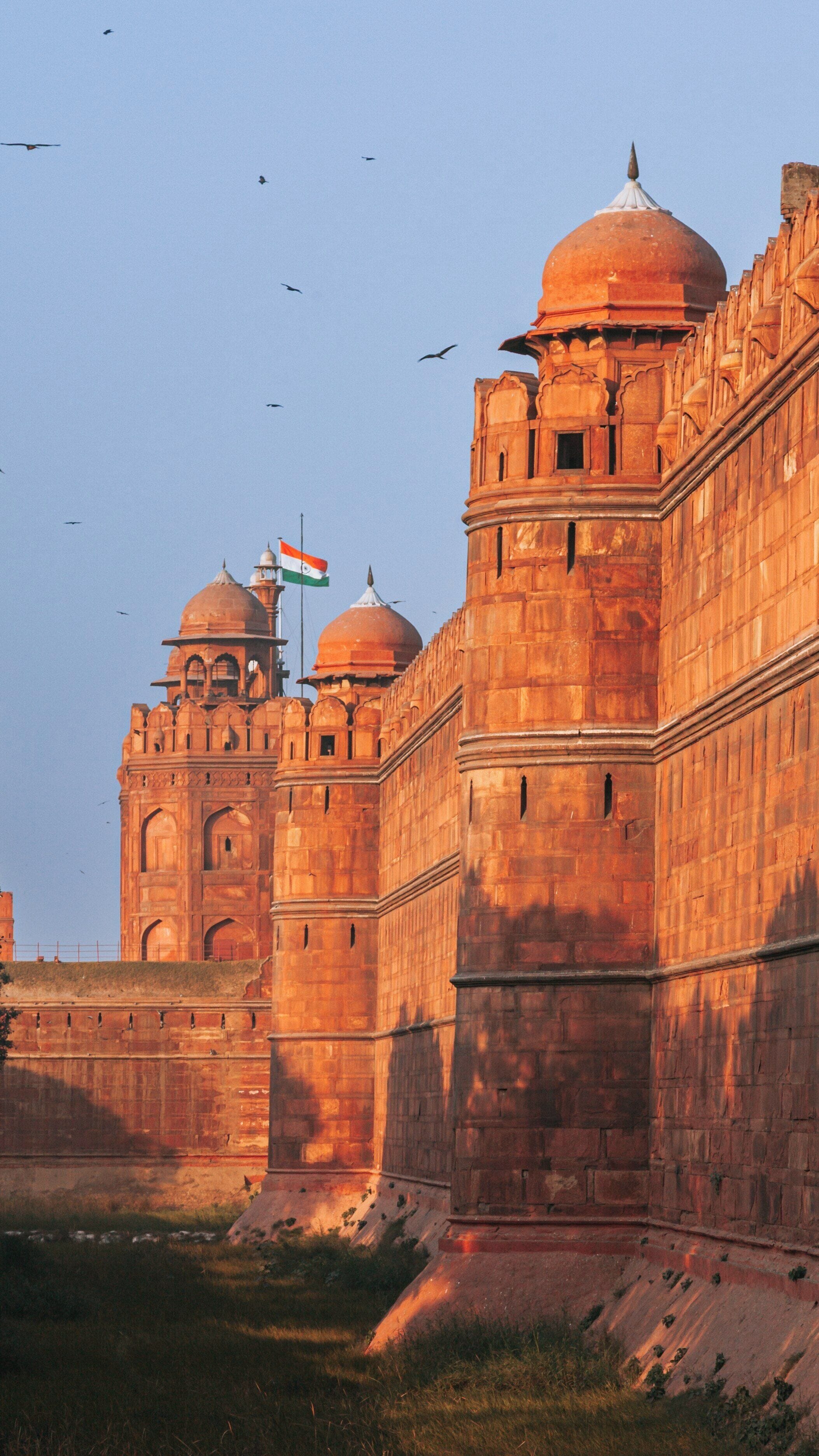 Explore the majestic Red Fort in Old Delhi at sunset showcasing its historical architecture and vibrant colors reflecting Indian heritage
