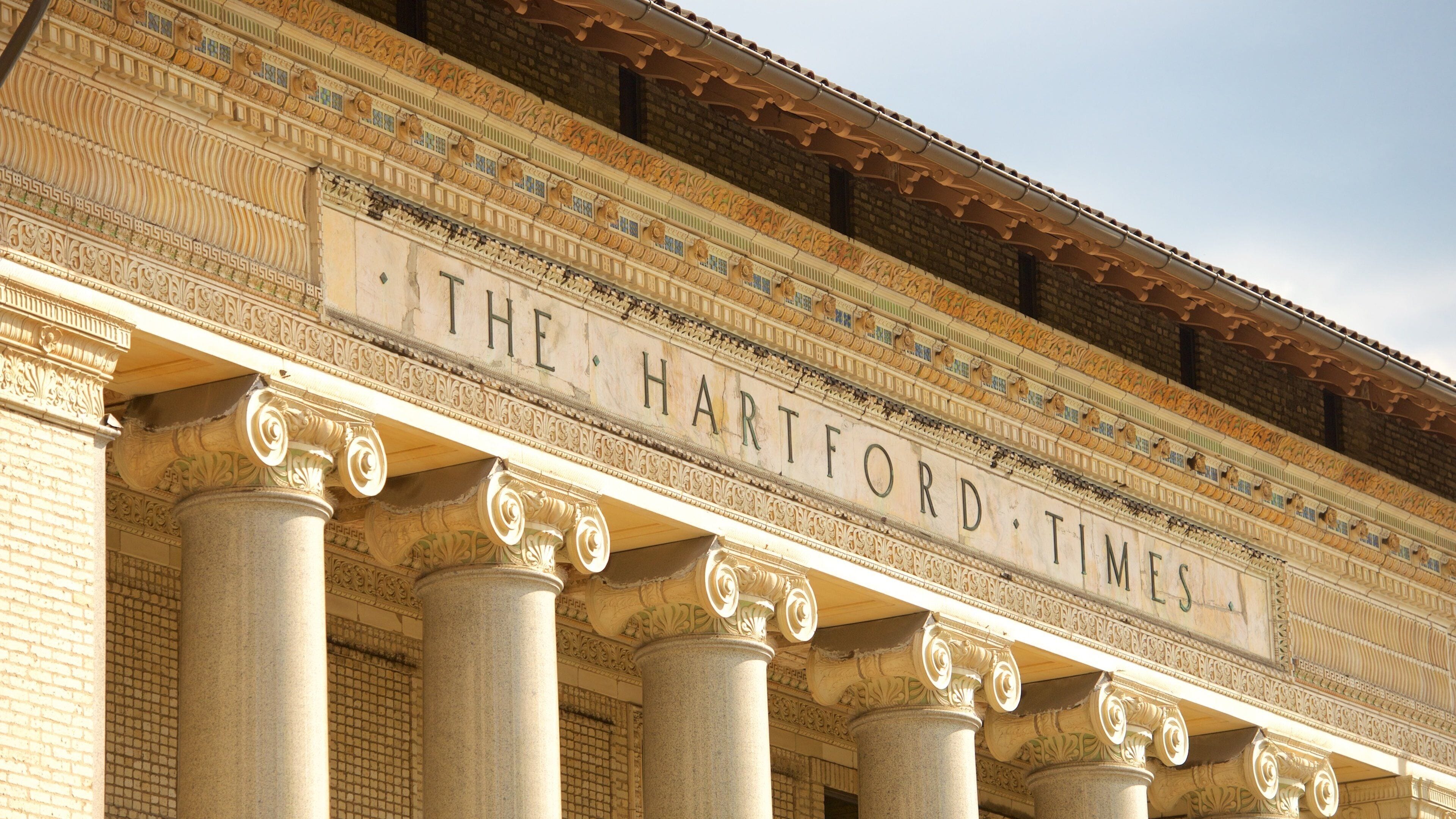 The facade of The Hartford Times building with ornate columns and detailed brickwork.