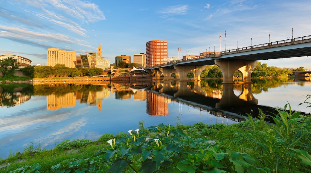 Beautiful sunrise over Connecticut River at Hartford Connecticut. Photo shows the skyline of Hartford, Founders Bridge and Bulkeley Bridge, which is the oldest highway bridges over Connecticut Rive