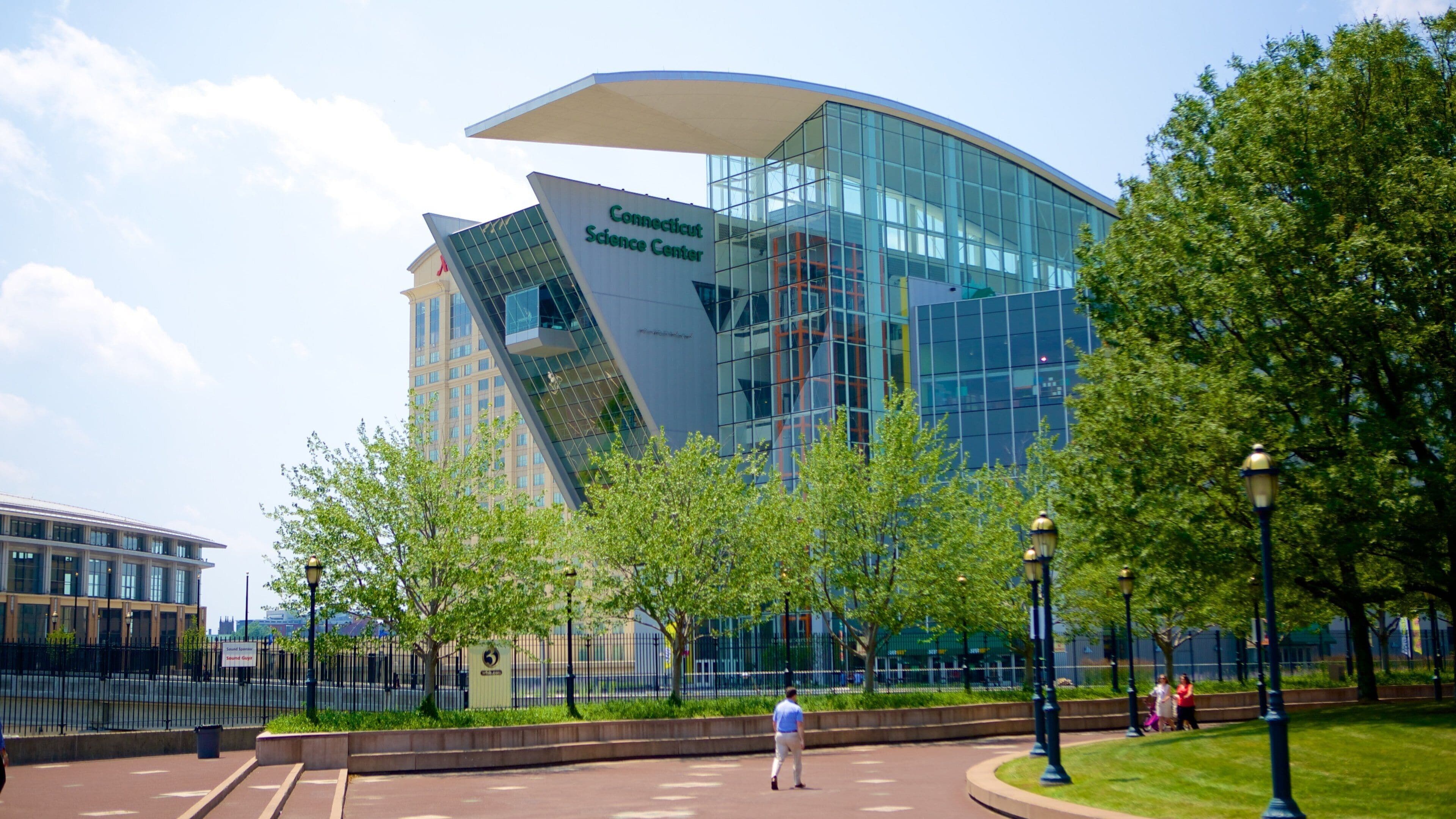 The Connecticut Science Center with a modern glass building and surrounding greenery.