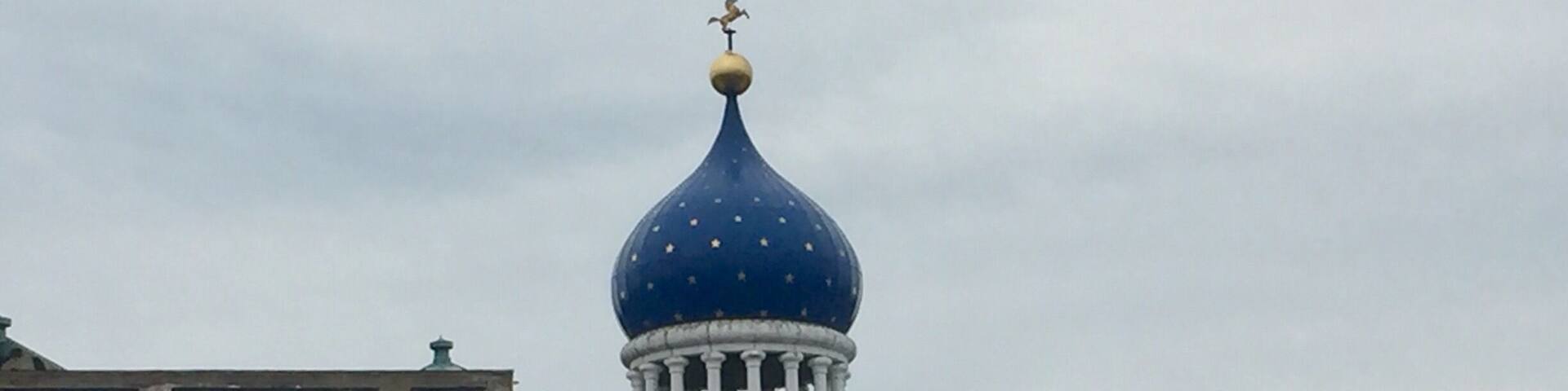 Underneath that blue dome lies the east armory of a factory once owned by a man who changed American history, the innovator of the revolver, Samuel Colt. Sprawling around the crumbling red brickwork of the old Colt’s Patent Firearms Manufacturing Company, once the largest private armory in the world, are the remnants of Coltsville, the utopian village he built for his workers.
A model of 19th century industrial paternalism, Coltsville included a church, a social hall for dances and lectures, workers’ housing, a giant landscaped park home to deer and peacocks, sculpted botanical gardens, and thousands of feet of greenhouses filled with tropical fruit and flowers. Samuel Colt felt such responsibility for the welfare of his workers outside the factory that he went so far as to build Potsdam Village, to replicate the feel of the German village from which he imported his skilled craftsmen to work in his willow ware factory.
The National Park Service began having on-site presence in 2015, with workshops and tours, including up into the Blue Onion Dome which affords magnificent views of downtown Hartford, the Connecticut River and Colt Park, formerly the back yard of Armsmear, Samuel & Elizabeth Colt’s mansion. By 2016, an NPS ranger had taken up residence in the South Armory and was giving walking tours of Coltsville.
The old South, East and North armories are under renovation and the two 1855 brownstone buildings, the oldest structures on site, will become the National Park Service Visitor Center. The armories themselves have been or are being renovated into apartments, offices and education facilities.