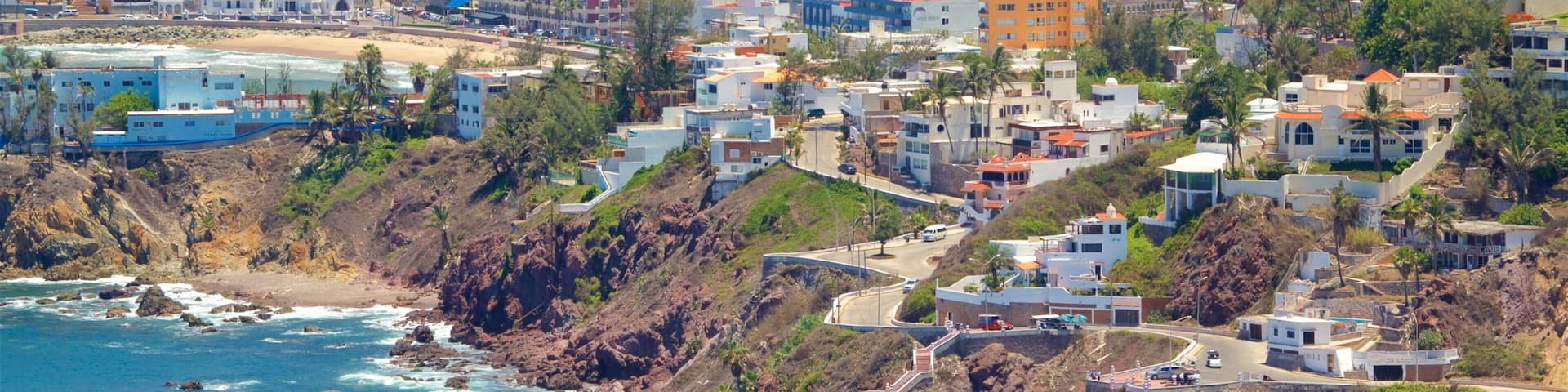 Mazatlan featuring rocky coastline, a city and landscape views