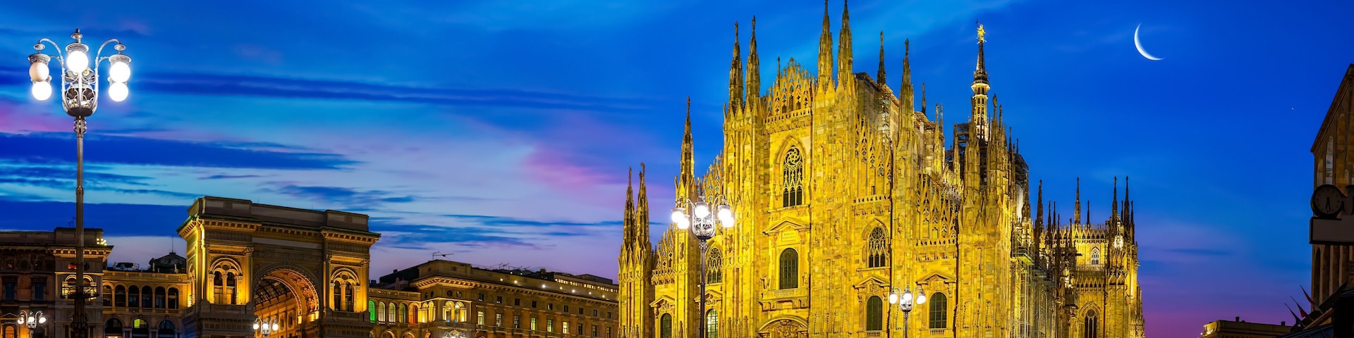 A grand cathedral with intricate Gothic architecture, illuminated at dusk.