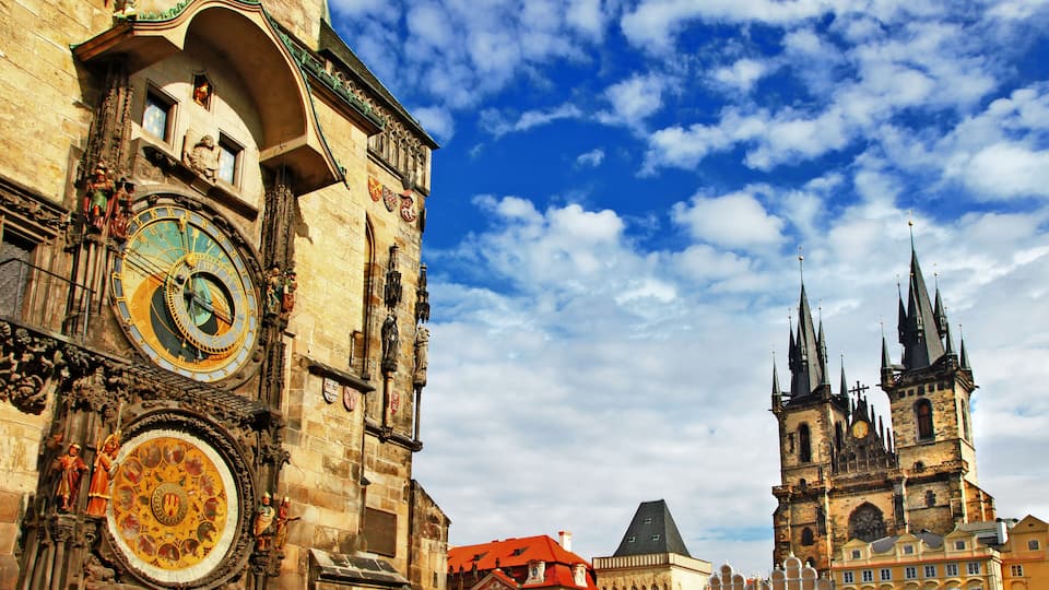 A historic building with ornate clocks and a prominent tower.