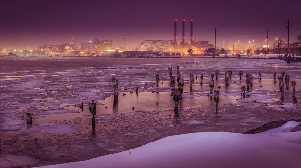 Cutting across town, I saw this view in my rear view mirror. I quickly pulled over, grabbed my camera and tripod, ran to the water's edge and took this photo just before the light changed. The background buildings and sky have such a unique color to them because it just started to snow