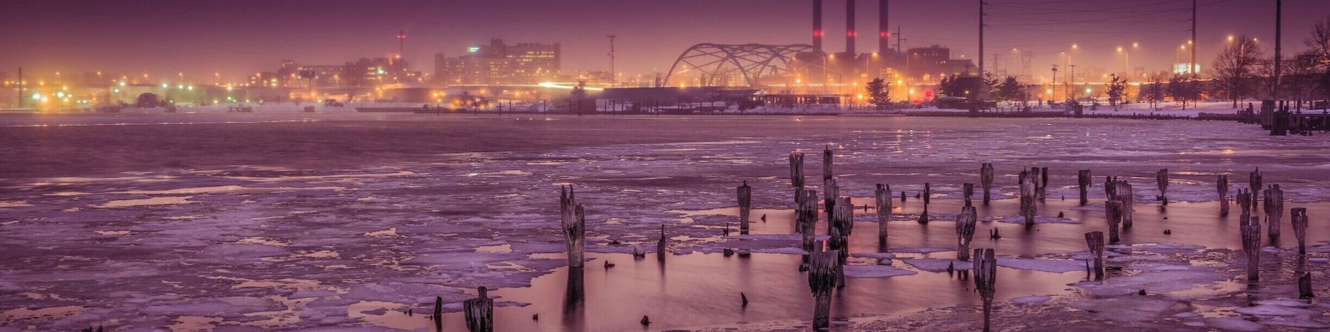 Cutting across town, I saw this view in my rear view mirror. I quickly pulled over, grabbed my camera and tripod, ran to the water's edge and took this photo just before the light changed. The background buildings and sky have such a unique color to them because it just started to snow