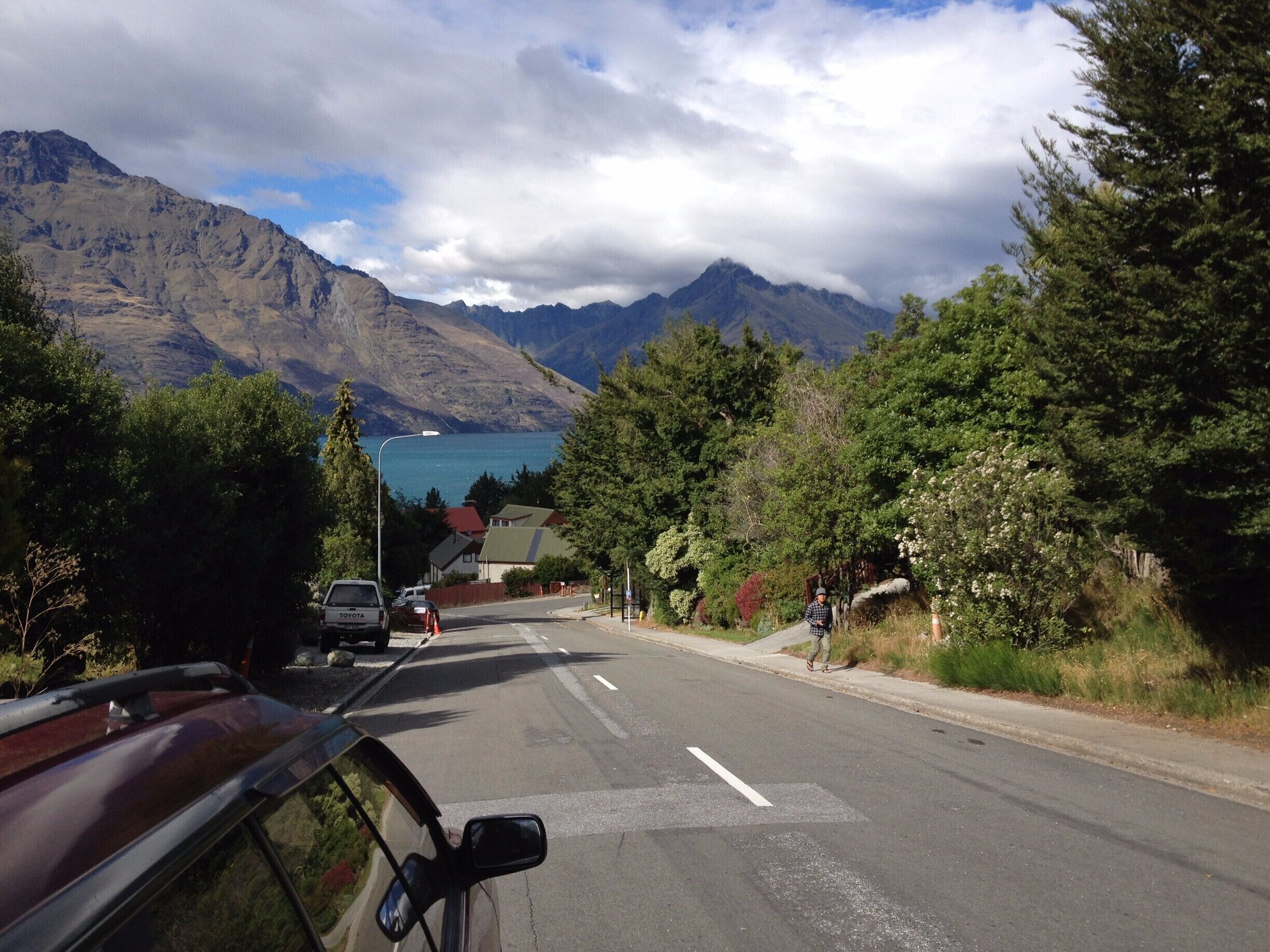 Fernhill Road neighbourhood in Queenstown, New Zealand. The scenic beauty of Lake Wakatipu and the Remarkables mountains is truly awesome. Was walking down this road looking for the corner shop, and was struck by this view, most unforgettable.