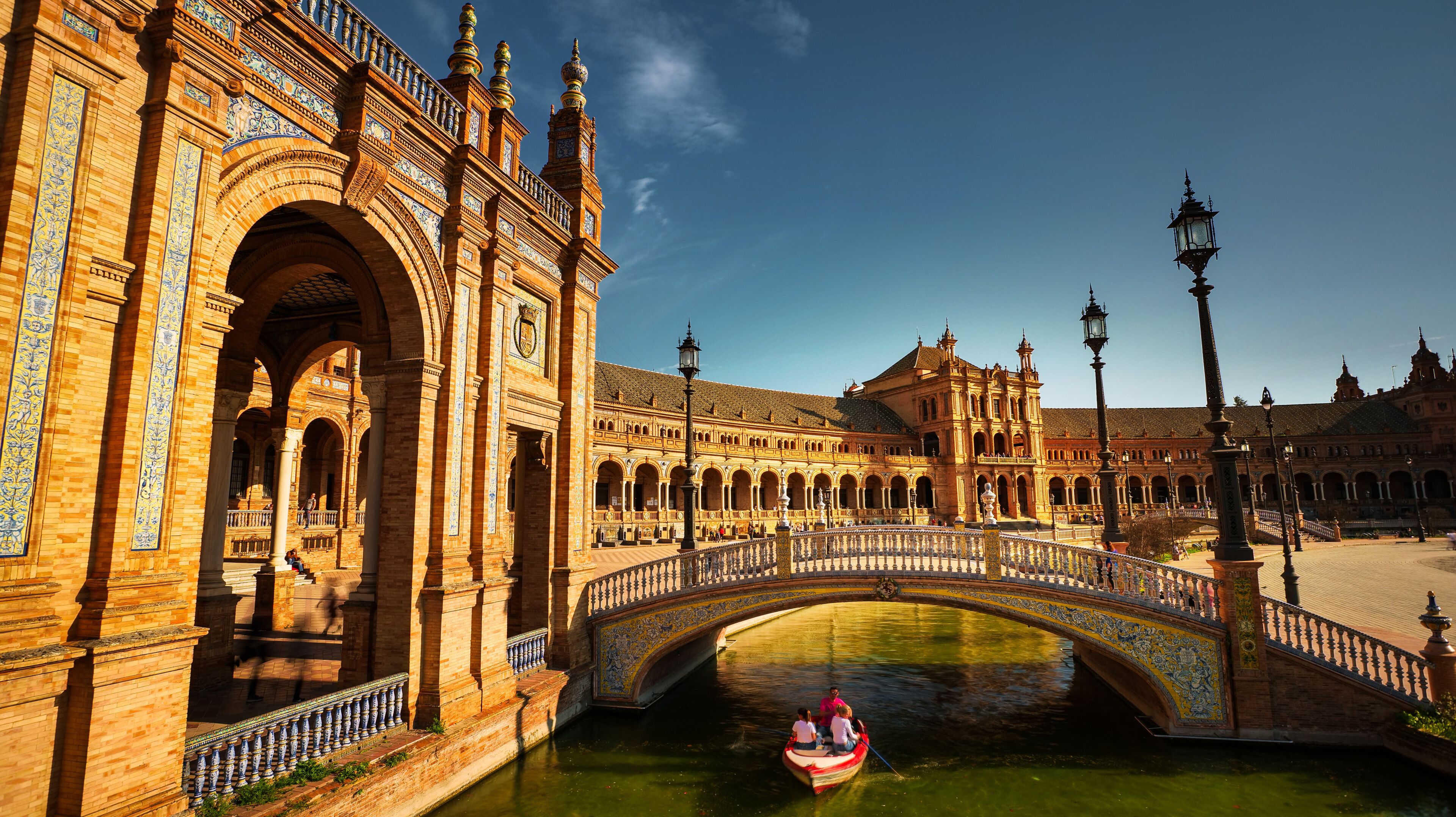 Seville, Spain - February 17th, 2020 - Seville Plaza de Espana / Spain Square with the view to the Bridges, rowing boats and Royal Palace with Architecture Details.